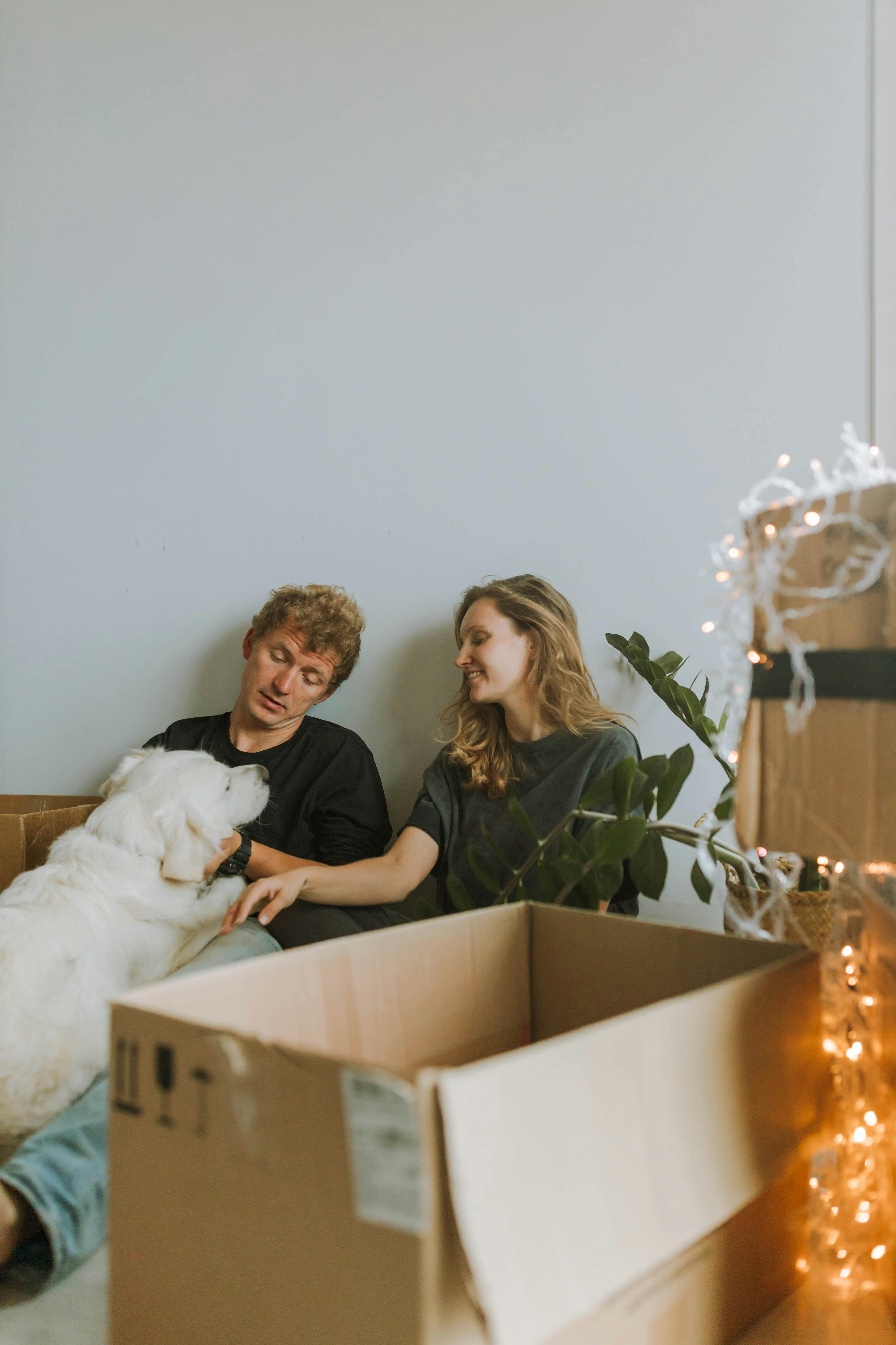 Man and Woman Cuddling Dog
